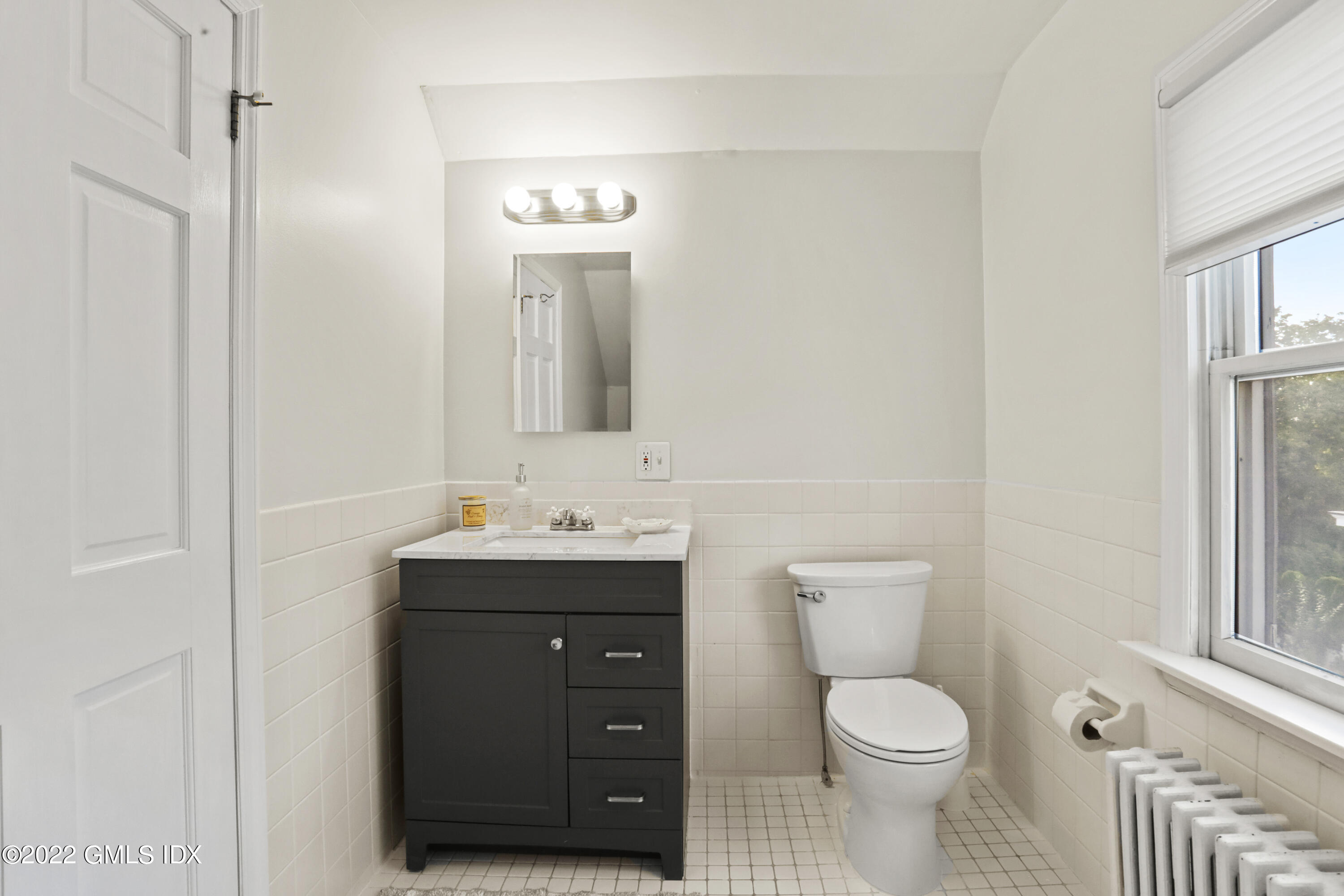 12 Maher Avenue Greenwich, CT 06830 - Photo 22 of 34 a bathroom with a toilet a sink a vanity and mirror