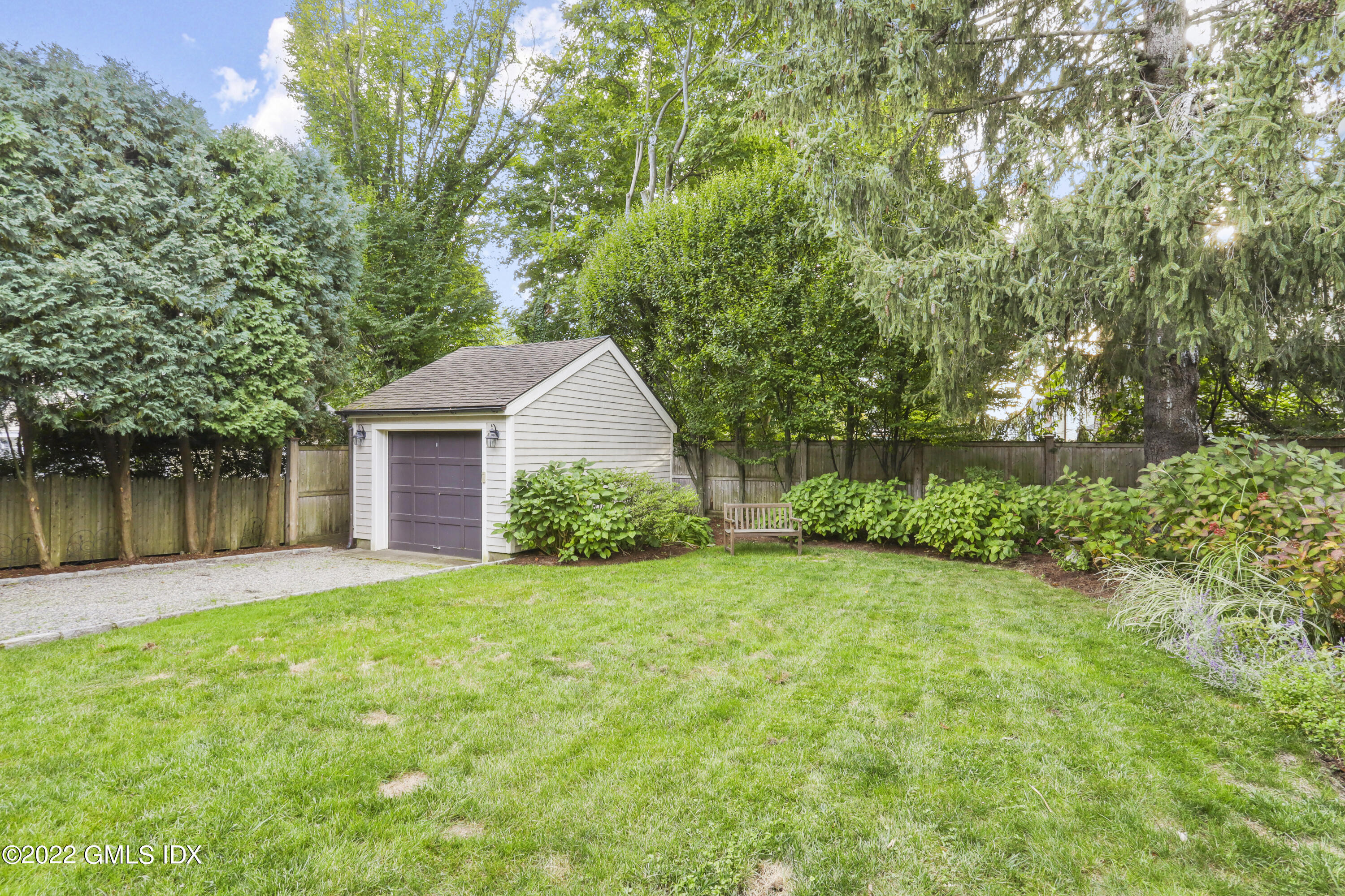 12 Maher Avenue Greenwich, CT 06830 - Photo 26 of 34 a front view of a house with a yard and trees
