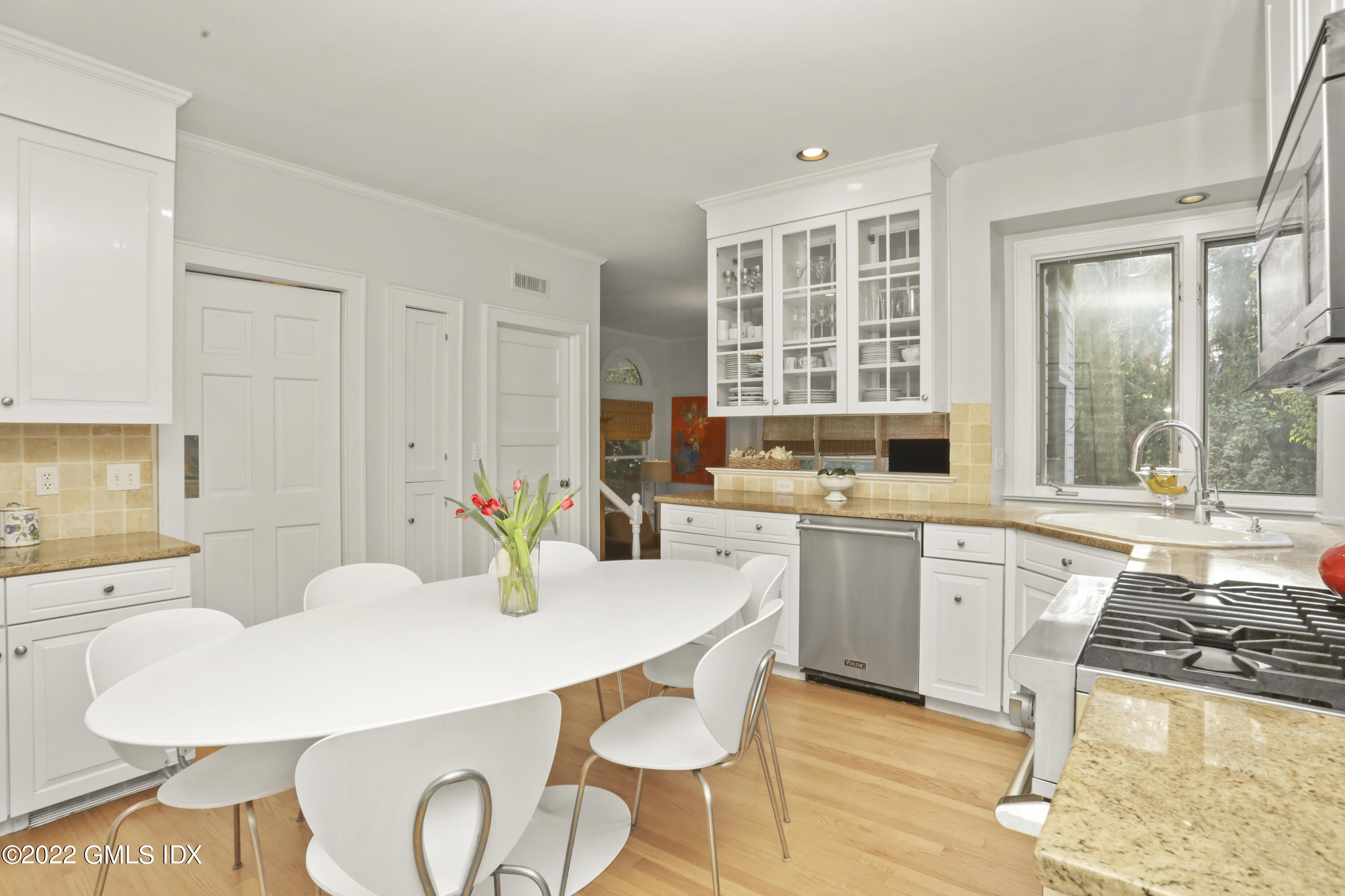 12 Maher Avenue Greenwich, CT 06830 - Photo 7 of 34 a kitchen with stainless steel appliances a dining table and chairs