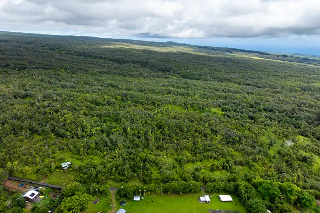 a view of a field with an ocean