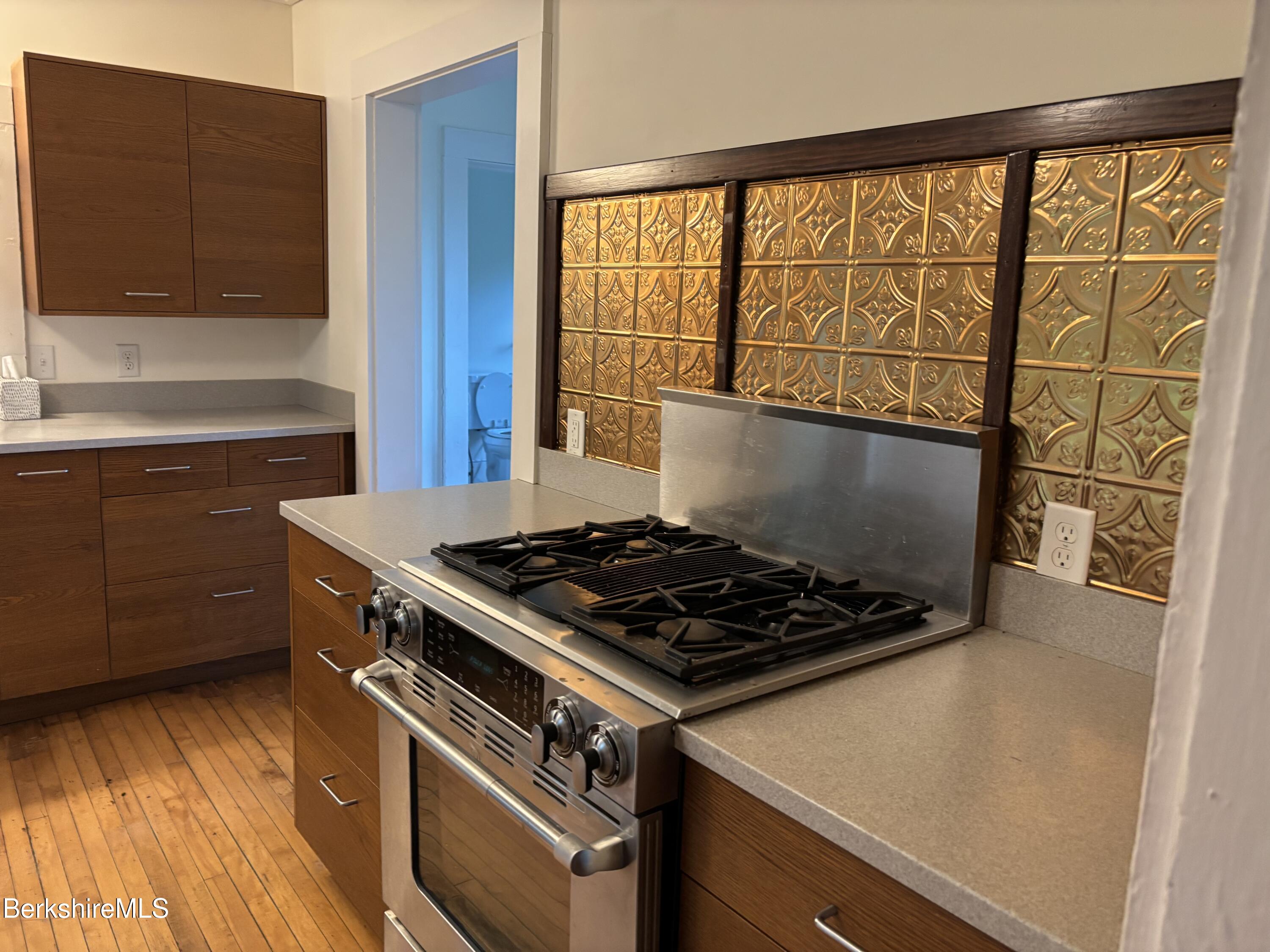 86 Miner Road Lanesborough, MA 01237 - Photo 27 of 44 a kitchen with wooden cabinets and a stove top oven