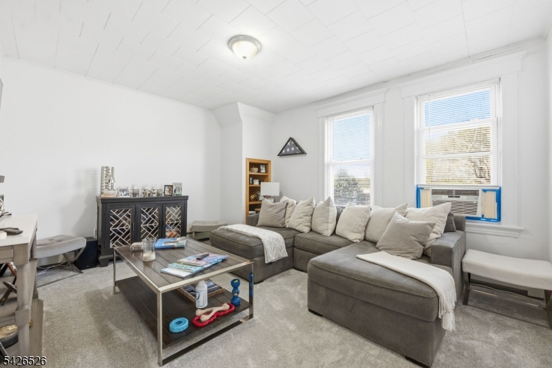 39 Wilmore Road, Unit 2 Little Falls, NJ 07424 - Photo 3 of 14 a living room with furniture and a large window