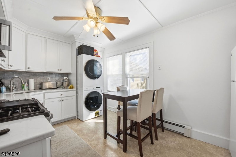 39 Wilmore Road, Unit 2 Little Falls, NJ 07424 - Photo 5 of 14 a kitchen with a table and chairs