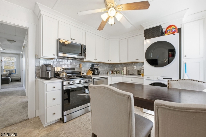 39 Wilmore Road, Unit 2 Little Falls, NJ 07424 - Photo 6 of 14 a kitchen with stainless steel appliances granite countertop a sink a stove and a wooden floors