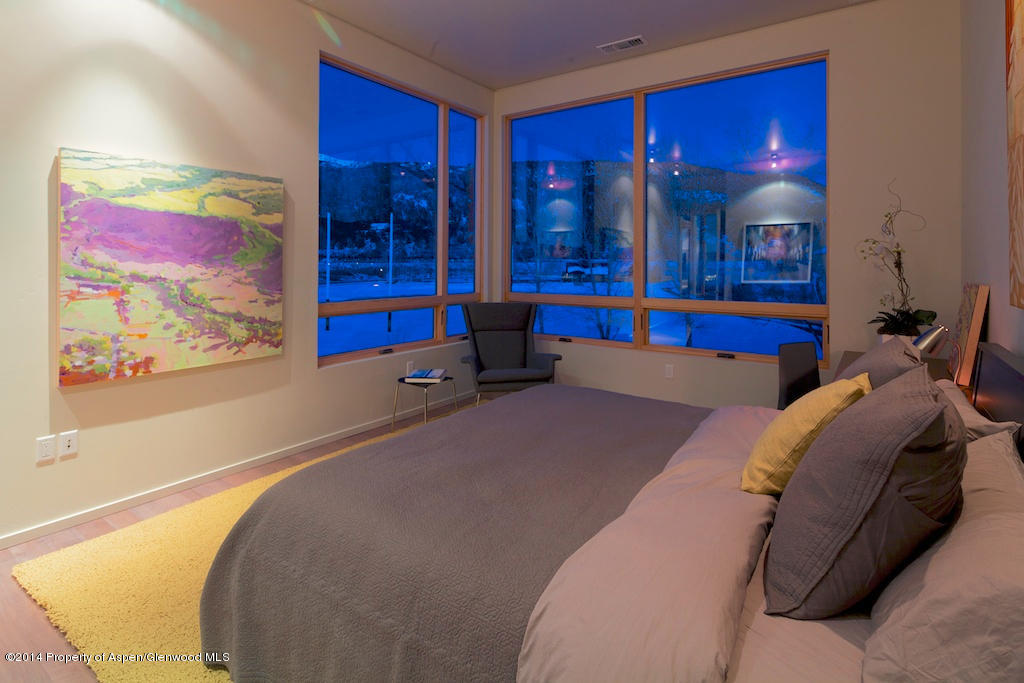 104 Evans Road, Unit 202 Basalt, CO 81621 - Photo 22 of 23 a bedroom with a bed and glass window