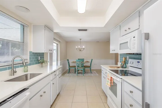 a view of a bedroom with wooden floor and fan