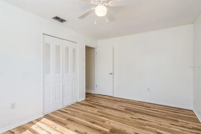 a bathroom with a granite countertop toilet sink and mirror