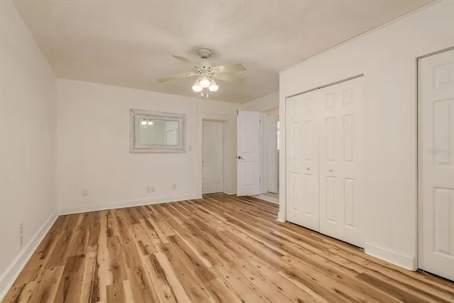 a view of a kitchen with white cabinets