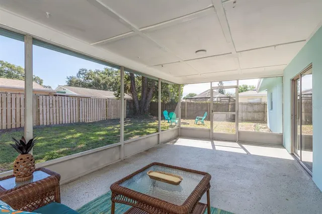 a view of a house with backyard and sitting area