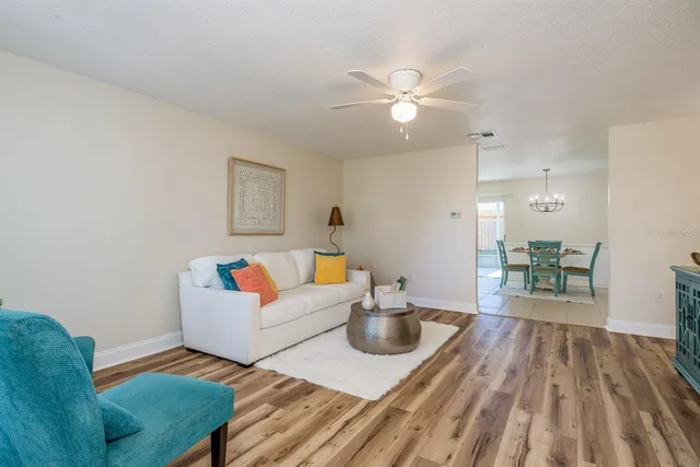 a living room with furniture and wooden floor