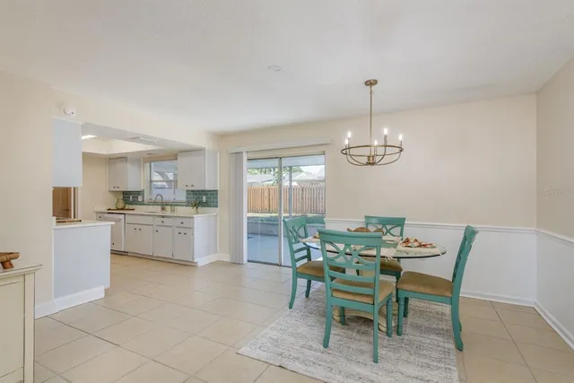 a dining room with a furniture and chandelier
