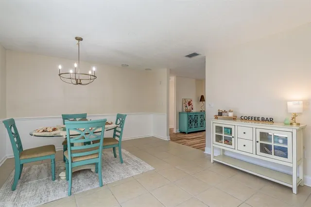 a kitchen with white cabinets and appliances