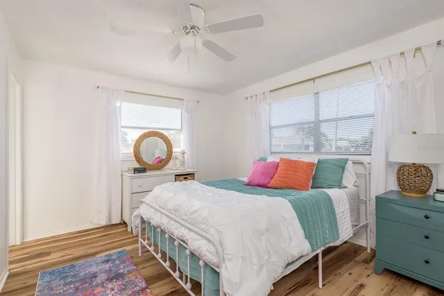 a bedroom with a large bed and a chandelier