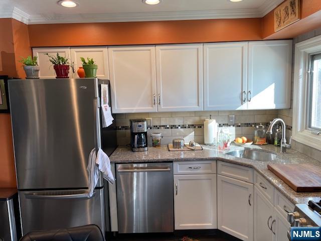 82 Herrick Street East Rutherford, NJ 07073 - Photo 11 of 26 a kitchen with stainless steel appliances granite countertop a refrigerator sink and cabinets