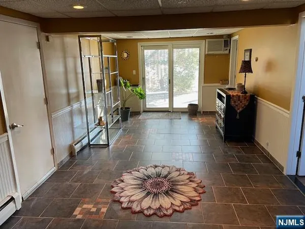 a view of entryway with a floor to ceiling window and wooden floor