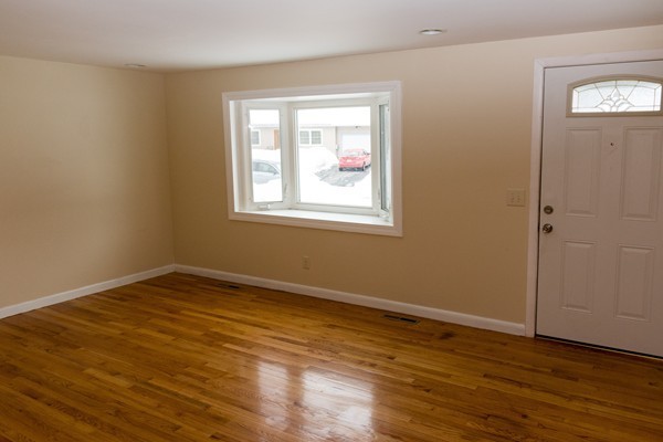 95 Saffron Circle Springfield, MA 01129 - Photo 5 of 17 a view of an empty room with wooden floor and a window