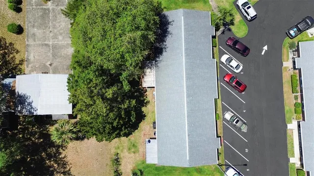 an aerial view of multi story residential apartment building with yard
