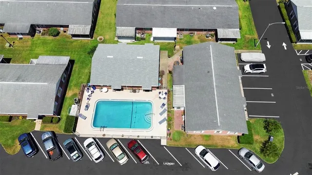 an aerial view of a house with a garden and pool