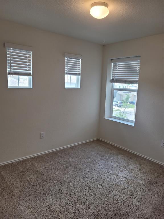 14917 Gypsum Mill Road Manor, TX 78653 - Photo 27 of 28 Well-lit room provides a neutral canvas for your personal style, offering comfort and simplicity.