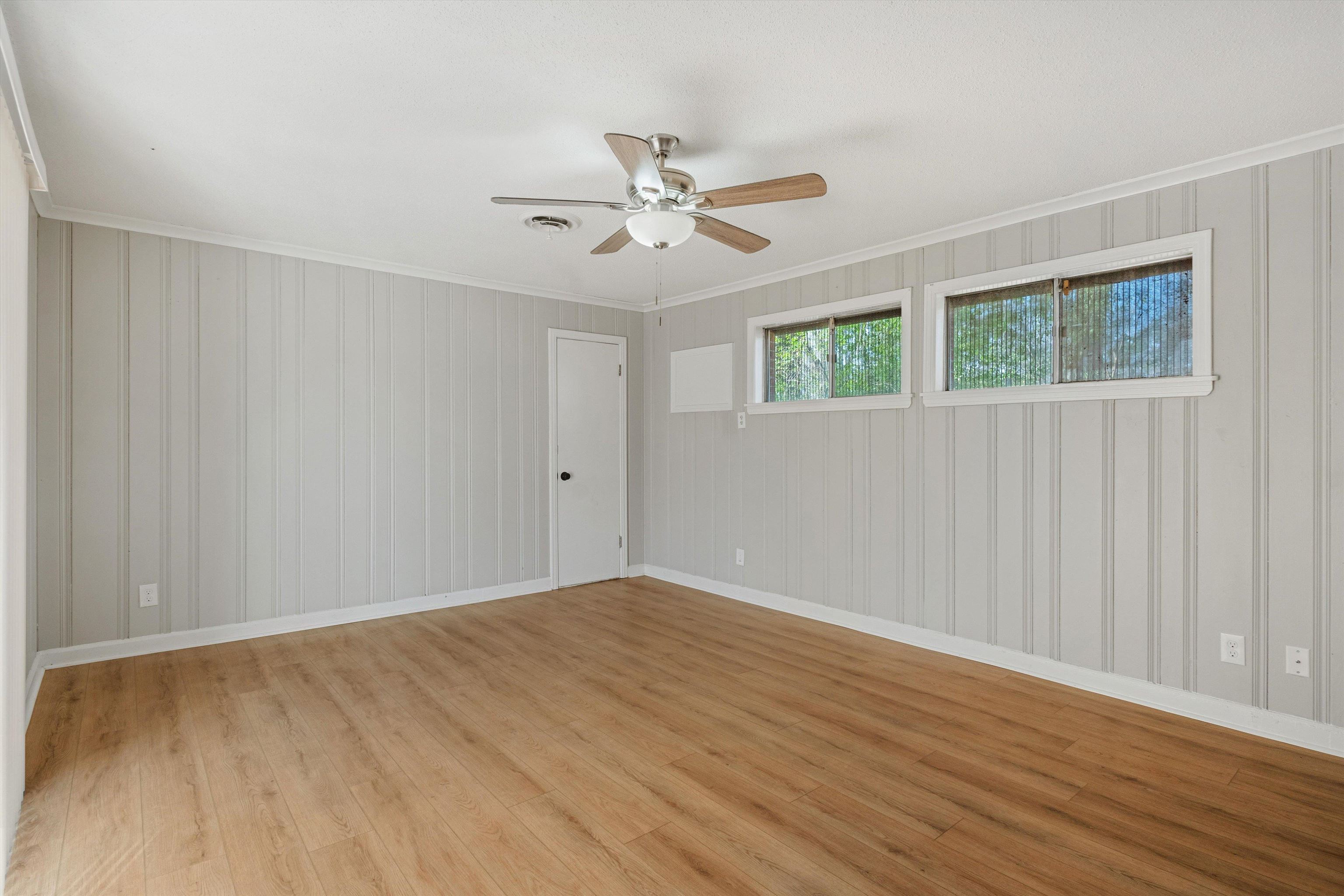 4487 East Dearing Road Memphis, TN 38117 - Photo 12 of 27 Spare room with light wood-style flooring, a ceiling fan, and ornamental molding