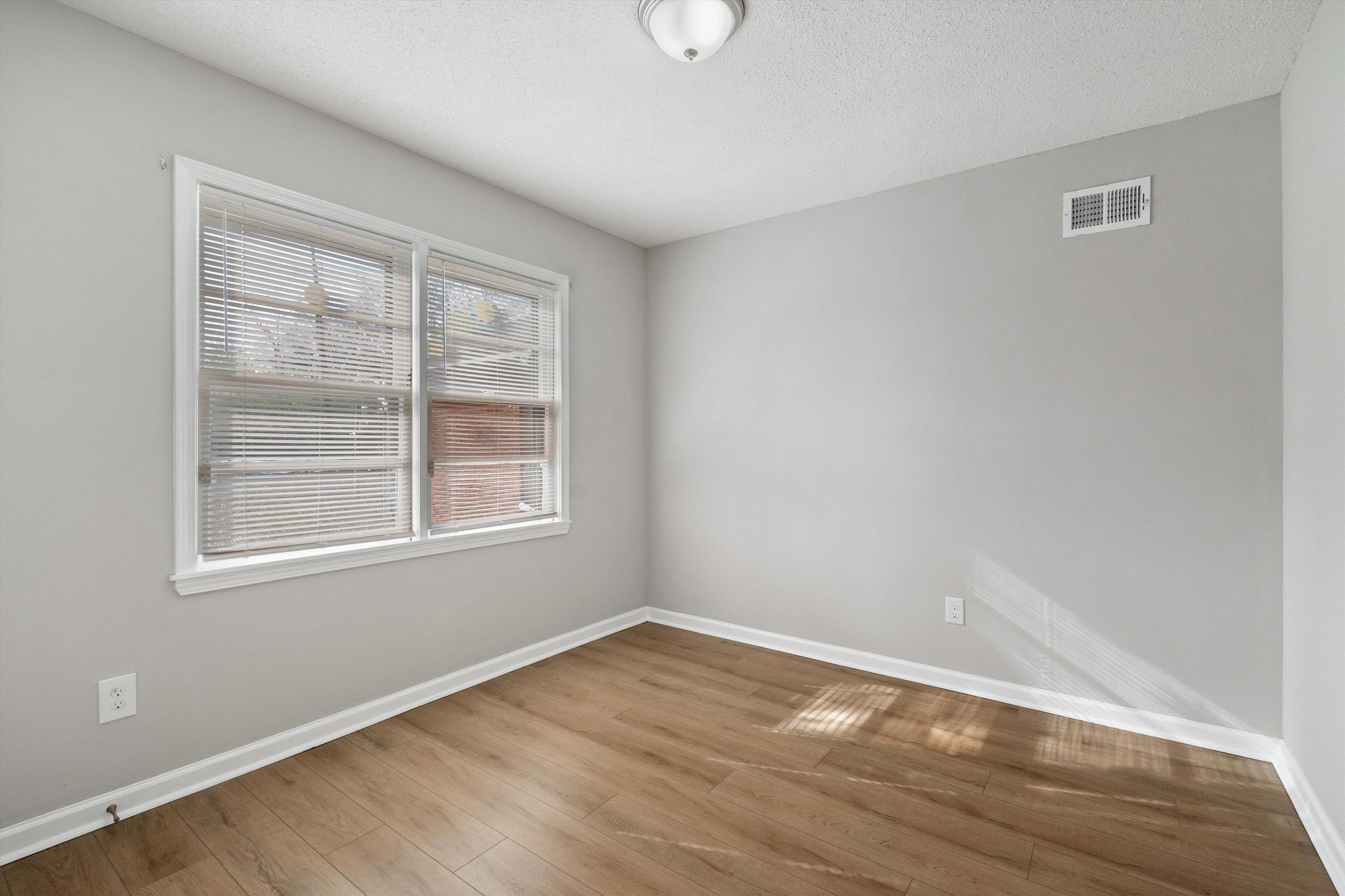 4487 East Dearing Road Memphis, TN 38117 - Photo 23 of 27 Empty room with wood finished floors and a textured ceiling