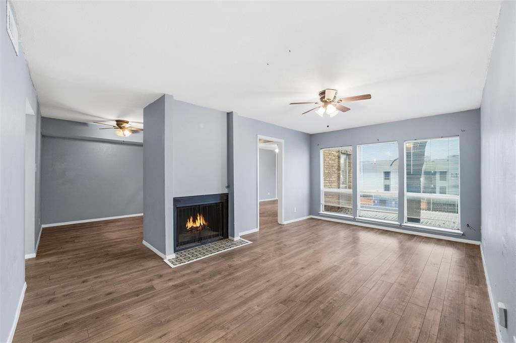 5604 Boca Raton Boulevard, Unit 248 Fort Worth, TX 76112 - Photo 3 of 25 a view of an empty room with wooden floor fireplace and a window
