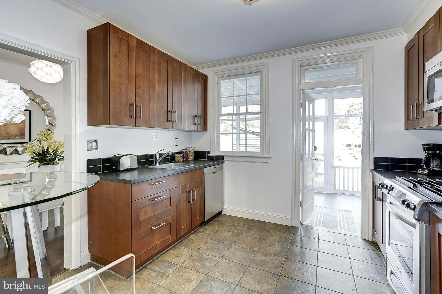 3707 Reservoir Road Northwest Washington, DC 20007 - Photo 9 of 19 a kitchen with stainless steel appliances granite countertop a stove a sink and a refrigerator