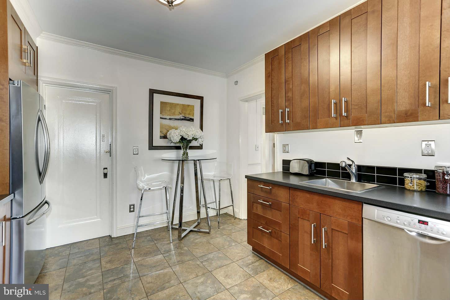 3707 Reservoir Road Northwest Washington, DC 20007 - Photo 10 of 19 a kitchen with stainless steel appliances granite countertop a refrigerator and a stove