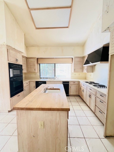 79990 Cedar Crest La Quinta, CA 92253 - Photo 16 of 19 a kitchen with stainless steel appliances kitchen island granite countertop a refrigerator oven a stove with white cabinets and granite countertops
