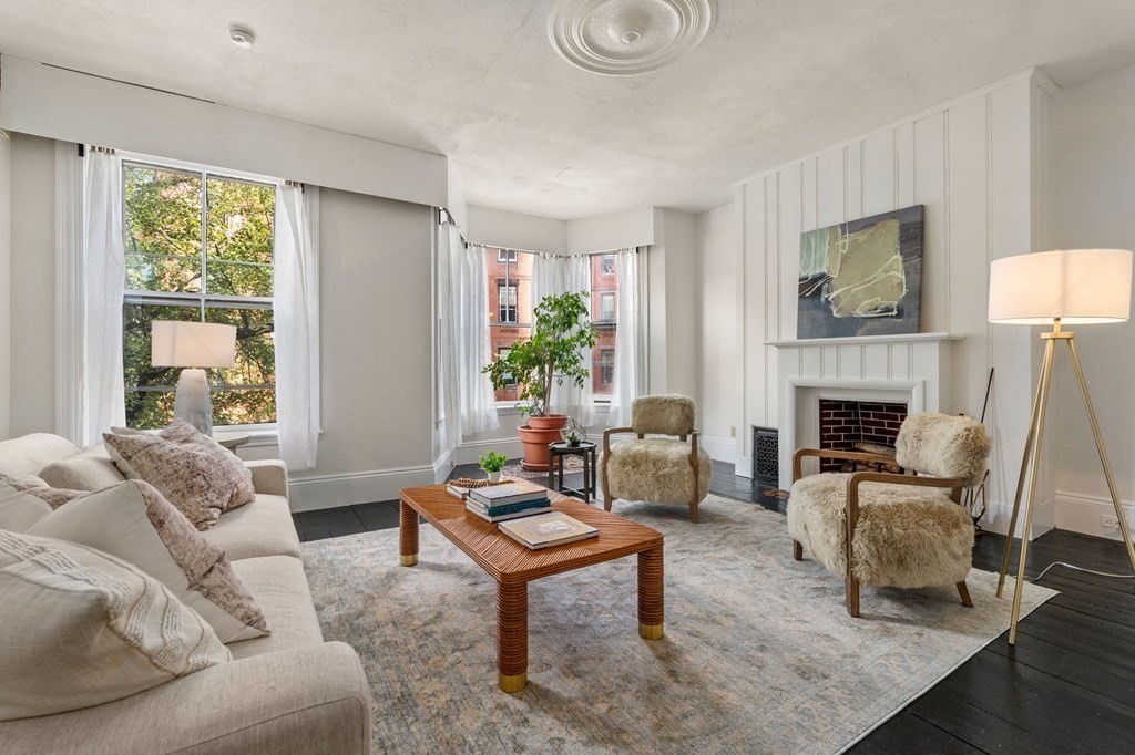 18 Symphony Road Boston, MA 02115 - Photo 12 of 34 a living room with furniture a fireplace and a table