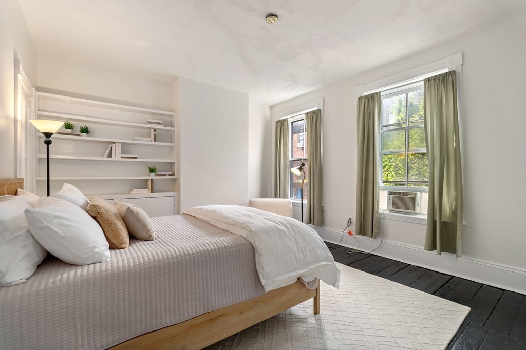 18 Symphony Road Boston, MA 02115 - Photo 16 of 34 a bedroom with a bed and wooden floor