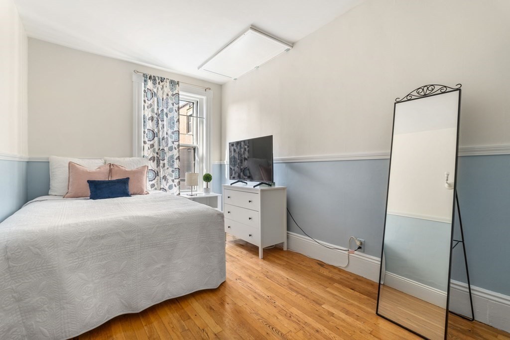 18 Symphony Road Boston, MA 02115 - Photo 21 of 34 a bedroom with a bed and a flat screen tv