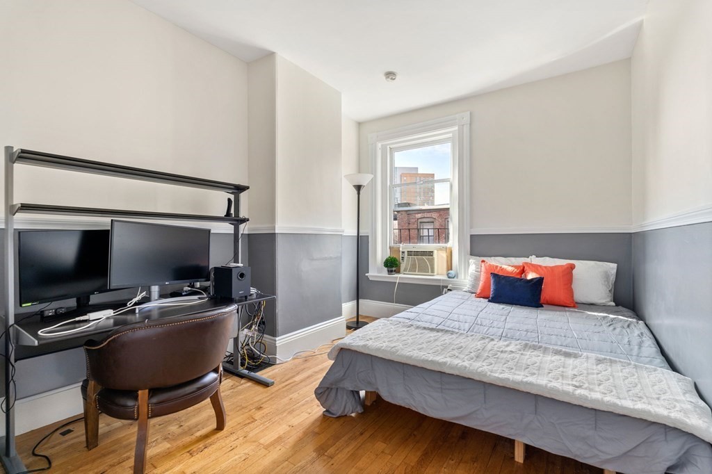 18 Symphony Road Boston, MA 02115 - Photo 22 of 34 a bedroom with a bed and a flat screen tv