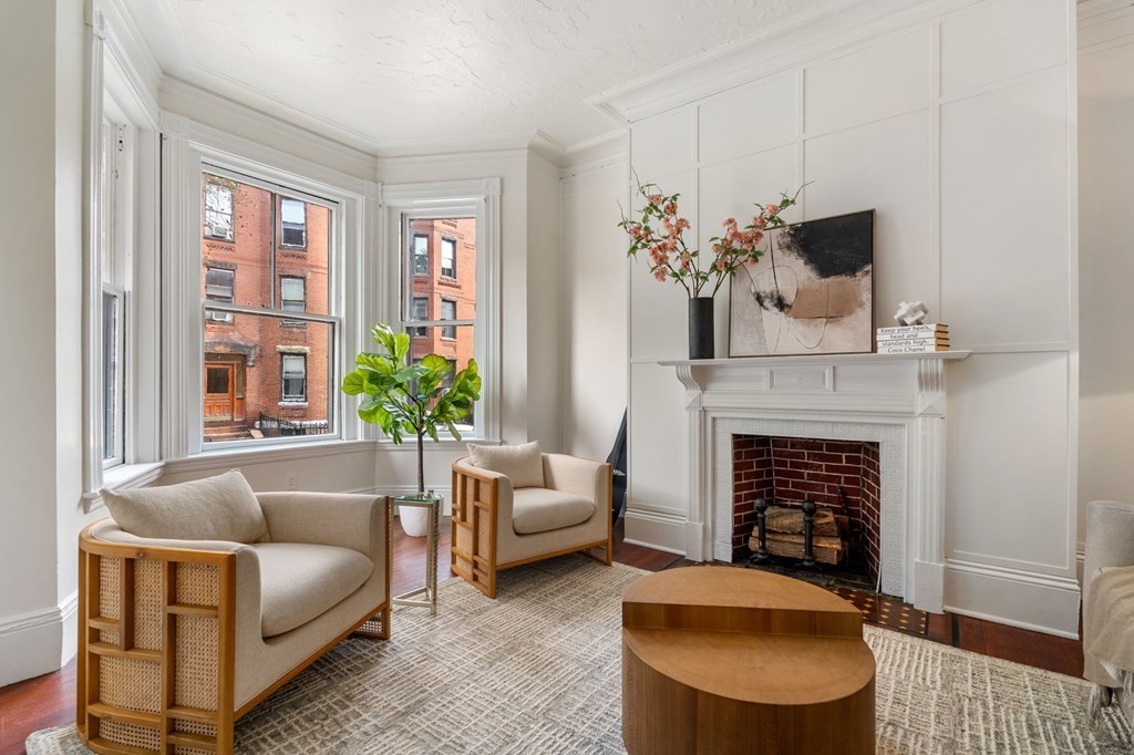 18 Symphony Road Boston, MA 02115 - Photo 4 of 34 a living room with furniture a fireplace and potted plants
