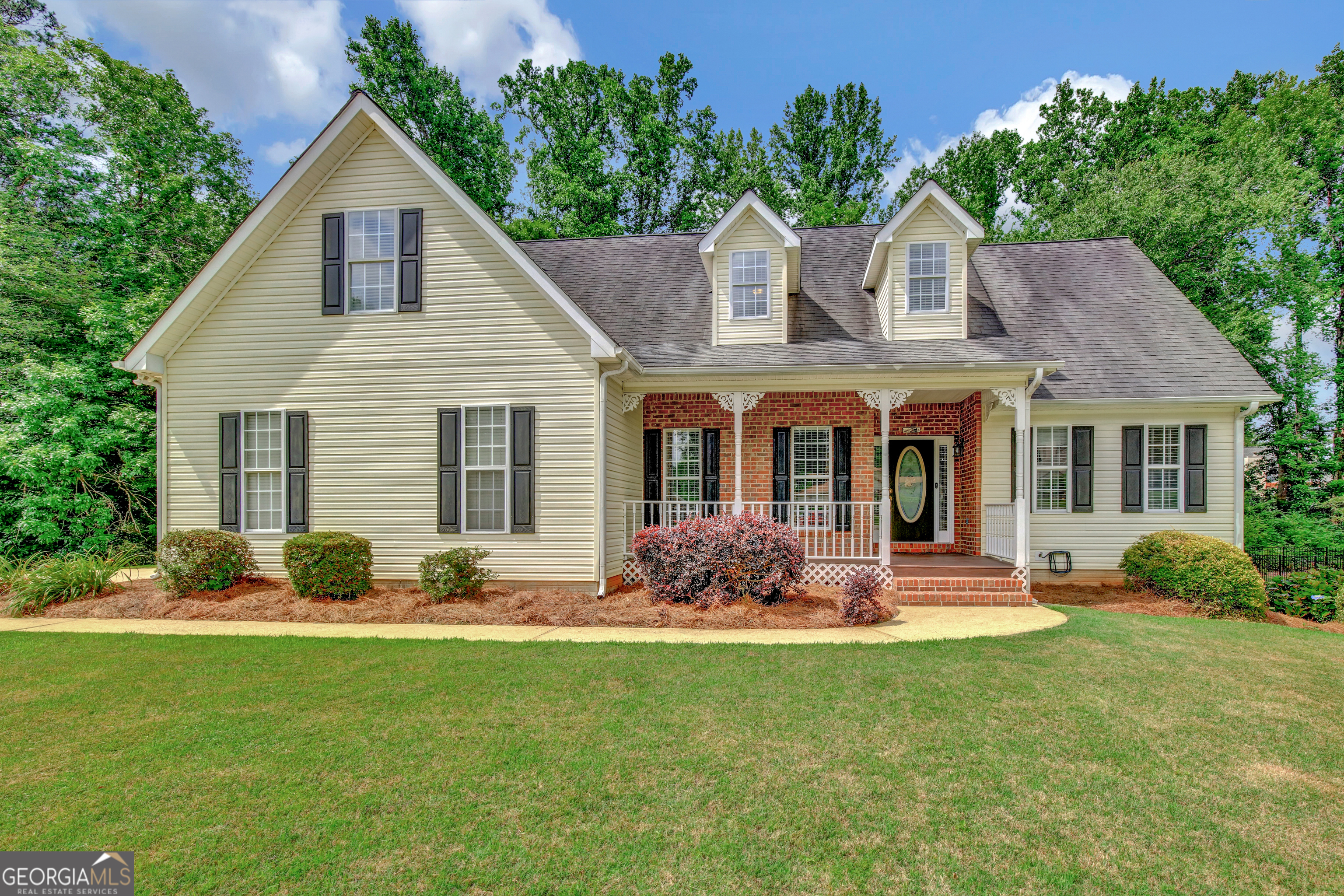 a front view of a house with garden