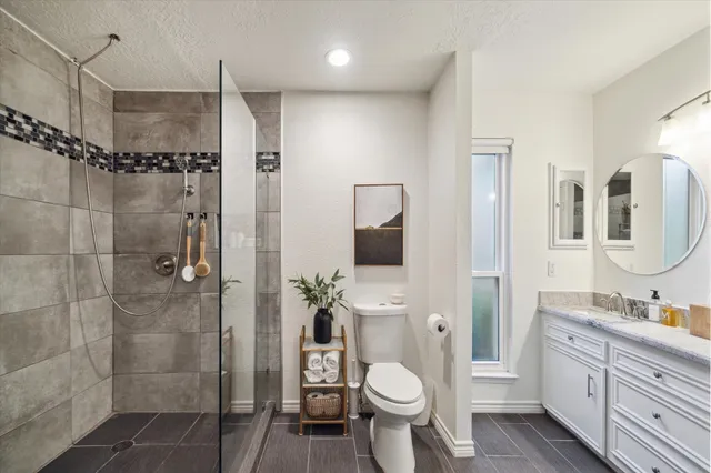 a bathroom with a sink toilet a shower and a mirror