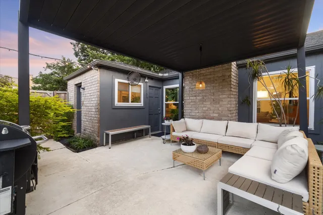 a balcony with furniture and a potted plant