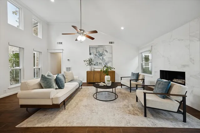 a living room with furniture a dining table and a fireplace