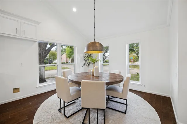 a dining room with furniture and wooden floor