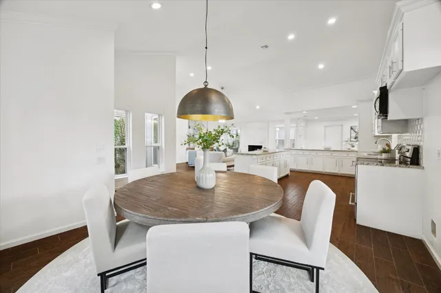 a kitchen with a table chairs and a refrigerator