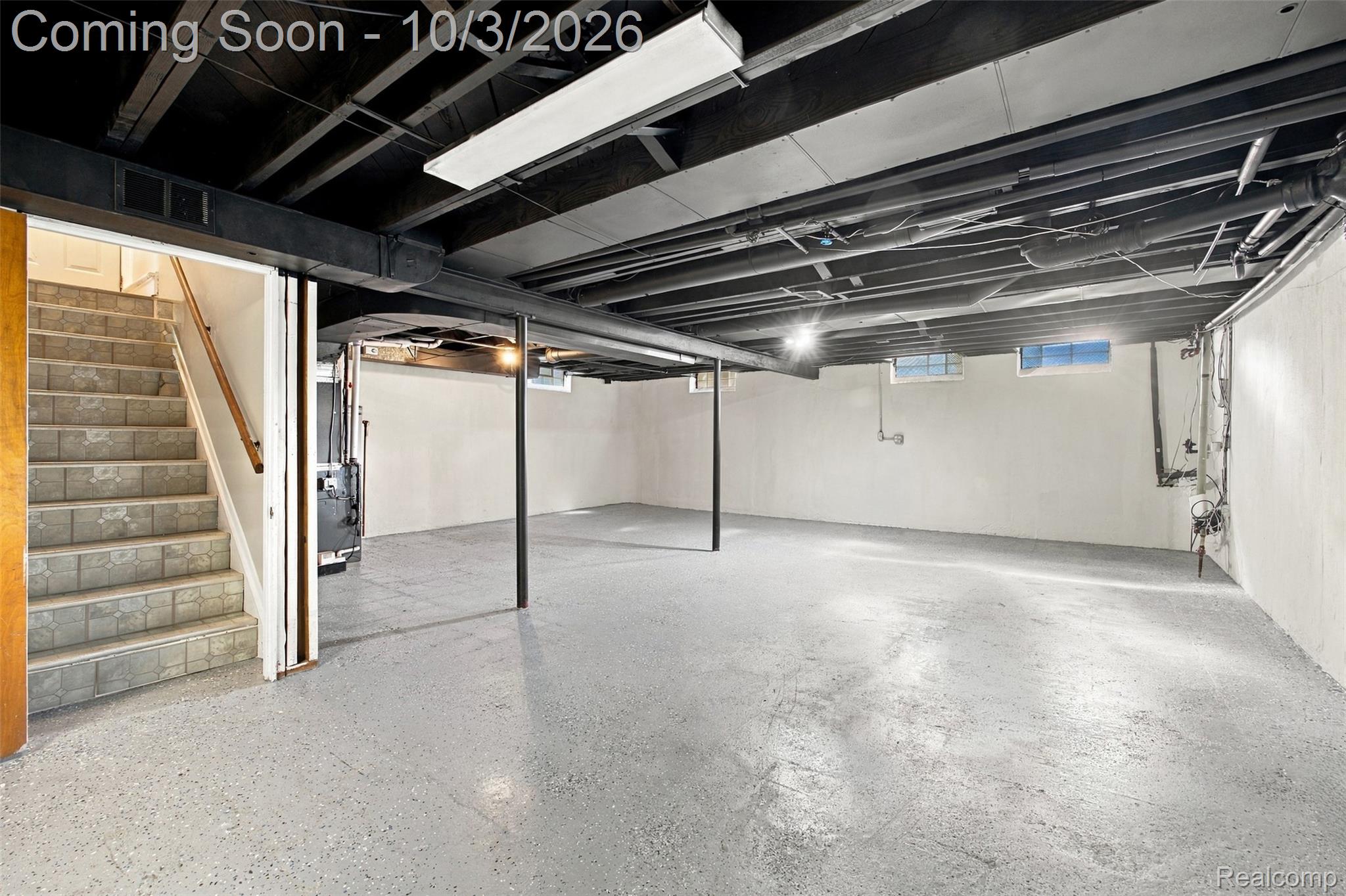 556 Henry Ruff Road Garden City, MI 48135 - Photo 24 of 49 Expansive unfinished basement featuring painted concrete flooring, painted white walls, and a painted black exposed ceiling