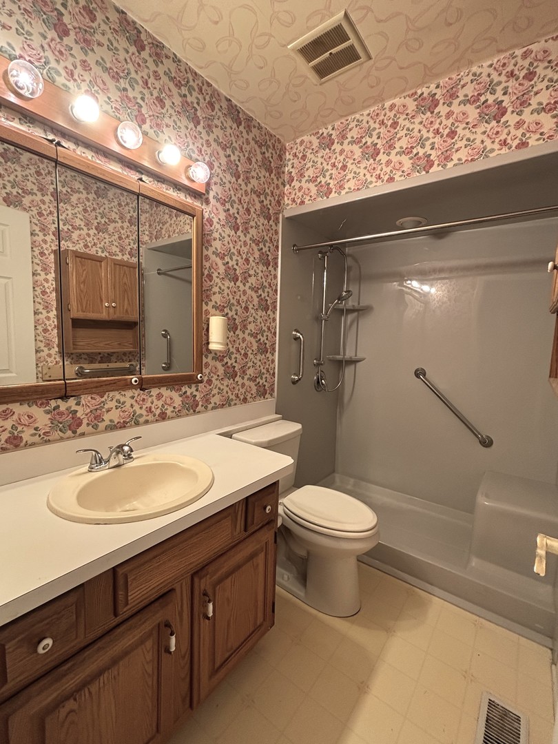 22 Guilford Road Montgomery, IL 60538 - Photo 10 of 14 a bathroom with a granite countertop toilet sink and mirror