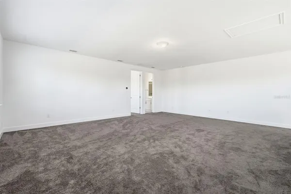 a bed room with a bed and a chair