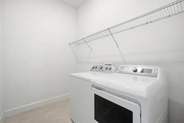 an aerial view of a swimming pool with outdoor seating and city view