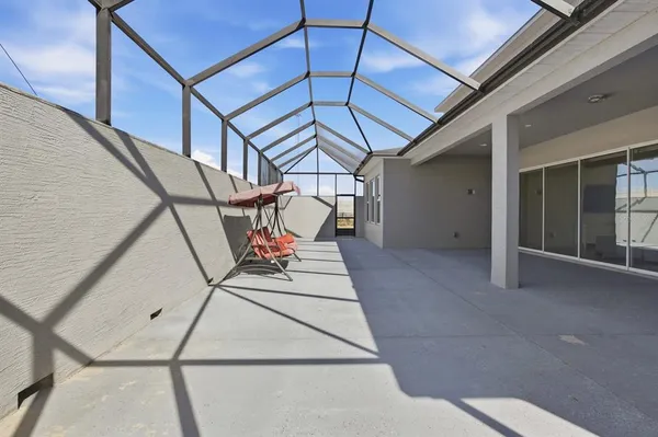 a view of swimming pool with outdoor seating and lake view