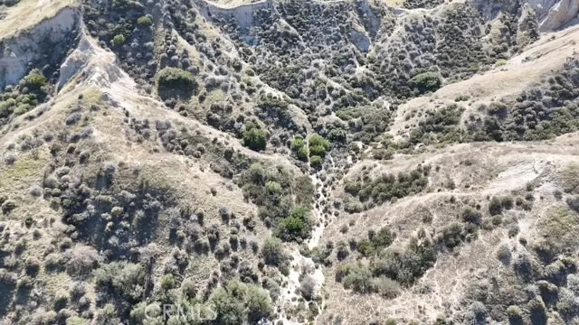 a view of a yard with wooden fence