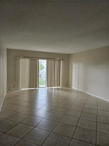 a view of an empty room with glass door