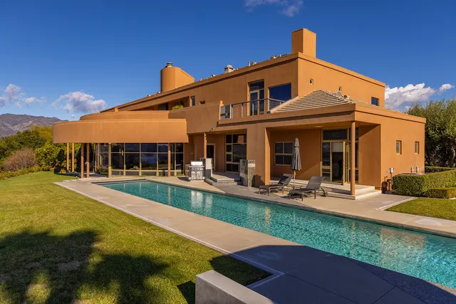 a front view of house with swimming pool yard and outdoor seating