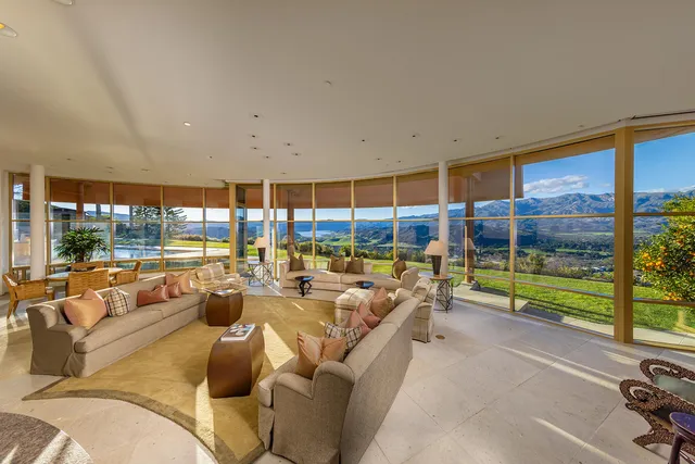 a dining room with furniture and a floor to ceiling window