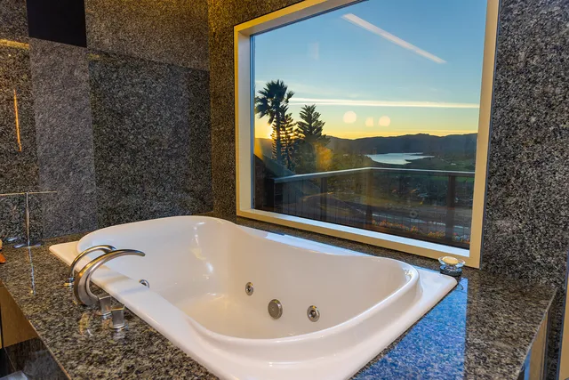 a spacious bedroom with a bed and a large window